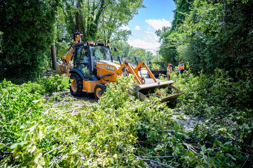 Loader clearing storm debris from a residential street